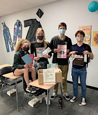 Sealy High School student councilmembers display items that have already been collected to donate to help children and teenagers in foster care systems as part of the group’s state project. Pictured are junior classmates Bailey Koy, Breanna Brandes, Carson Anderson and Julius Aguilar. (Contributed)