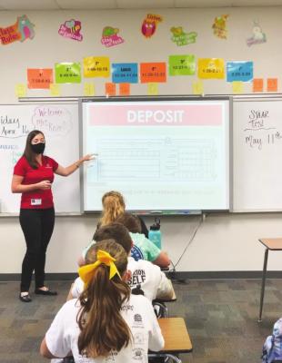 Industry State Bank’s Marketing Manager Rachel Kozel presents banking basics to students at Sealy Junior High School during a recent visit. CONTRIBUTED PHOTO
