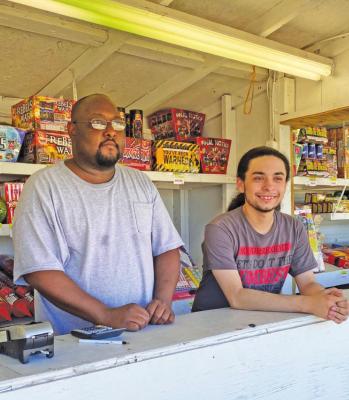 Floyd Kesee and Kyle Fentress spent the majority of their working hours at Mr. G Fireworks stand in the extreme heat this weekend with no customers. Due to the burn ban resulting from the drought, Kesee said this was the worst year for sales the stand has had in over 10 years.