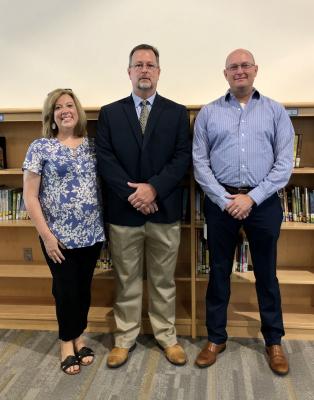 Jay Janczak, center, was approved by the Sealy ISD Board of Trustees as the principal at Maggie B. Selman Elementary at a special meeting last Friday morning at Sealy Elementary. He is pictured with his wife Jennifer and Sealy ISD Superintendent Bryan Hallmark. COLE McNANNA