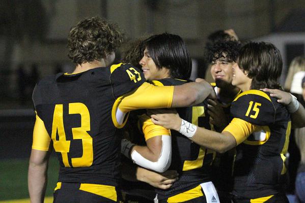 A group of Tigers embrace each other after Sealy’s 43-0, regular-season closing win over La Marque Friday night on Mark A. Chapman Field. Those pictured include William Forrester (43), Jonathan Monterroza (54) and Julius Aguilar (15). COLE McNANNA