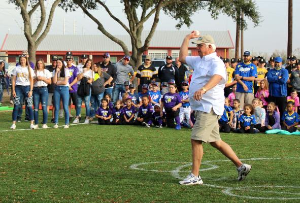 Gary Pless throws out an honorary first pitch during the ceremony on Mark A. Chapman Field as part of Greater Sealy Little League’s Opening Day festivities Saturday morning. AMANDA LUKSHA
