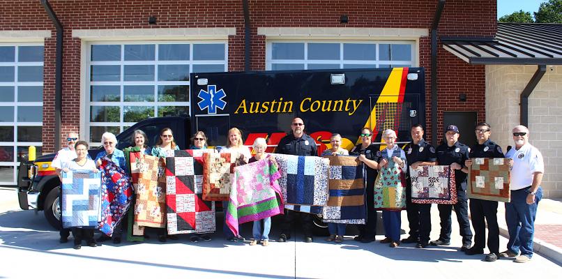 The Cotton Boll Quilters donated quilts to the EMS Station No. 2 in Sealy May 5. Pictured from left to right are Chief Walter Morrow, Susie Stigall, Julia Johnston, Teresa Henry, Lillie Spillars-Svec, Sandy Lewis, Theresa Enax, Grace Holtkamp, John Stanford, Judith Washburn, Katherine Podeszwa, Deanna Creekmore, Captain Gary Stansbury, Jordan Hoegemeyer, Mike Lee and Assistant Chief Gary Scarborough. Not pictured from the Cotton Boll Quilters is Rita Gomez. COLE MCNANNA