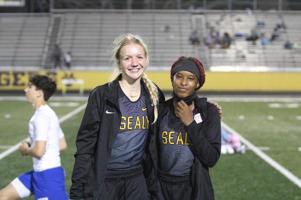 Sealy Lady Tigers Breanna Brandes and Taniah Coleman pose for a picture on Mark A. Chapman Field at the annual Sammy Dierschke Relays last Thursday at T.J. Mills Stadium where the pair set school records to help Sealy win its host meet. (Cole McNanna/Sealy News)