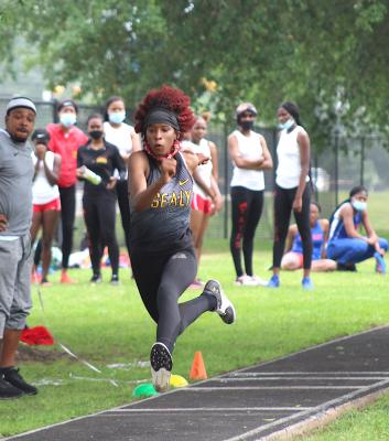 Sealy freshman Taniah Coleman soars through the air during the triple jump event at last Wednesday’s Area Championship at T.J. Mills Stadium. Coleman qualified for regionals in all five of her events. (Cole McNanna/Sealy News)