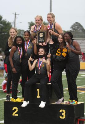 The Sealy Lady Tigers won the team competition at last Wednesday’s track and field Area Championship hosted at T.J. Mills Stadium. Pictured standing from left to right are Ella Ward, Hollie Brown, Dejua Posada, Courtney Roberts, Breanna Brandes, Annabelle Williams and DJ Johnson with Valerie Hahn sitting in front. (Cole McNanna/Sealy News)