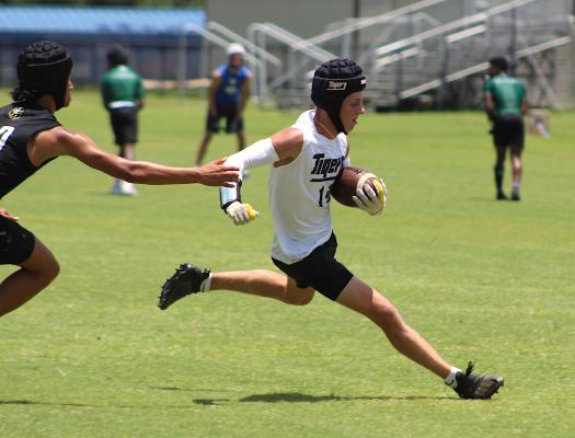 Tiger receiver Haden Wernecke bends away from a Jordan defender during Sealy’s 7-on-7 action at Taylor High School June 23. COLE McNANNA