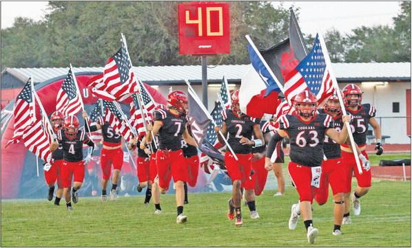 In honor of Sept. 11, 2001, Brazos football players charged onto the field before their game with Louise with American flags. PHOTOS BY JIMMY GALVAN