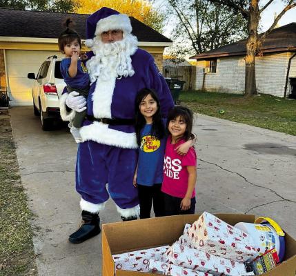 Sealy’s Blue Santa paid a visit to many Sealy children this season handing out gifts through the department’s Blue Santa program. CONTRIBUTED PHOTO