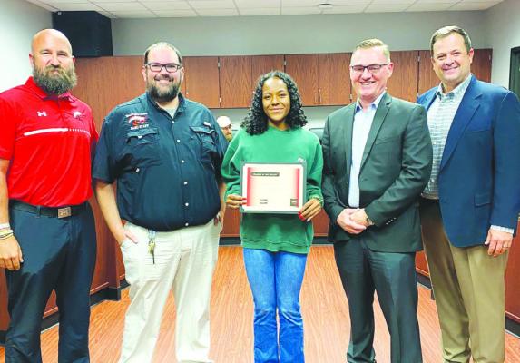 Brazos ISD recognized Brazos High School student, Camille Combie, at the March regular board meeting. BMS Principal, Clay Hudgins, shared that Camille is highly involved in extracurricular activities and works well in and out of the classroom. She is a great all-around student. Pictured with Camille is ,from left to right, Ryan Roecker, Athletic Director, Allynn Garcia, Director of Fine Arts, Camille, Scott Rogers, Superintendent and Clay Hudgins, BMS Principal. COURTESY PHOTO