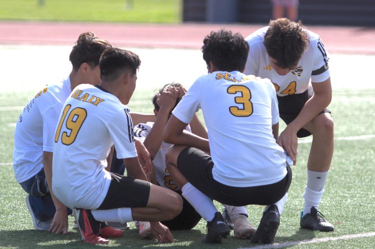 The Tigers console their captain #2 senior Maximino Requena after losing the game, where he put in a decisive own goal in the final 5 seconds.